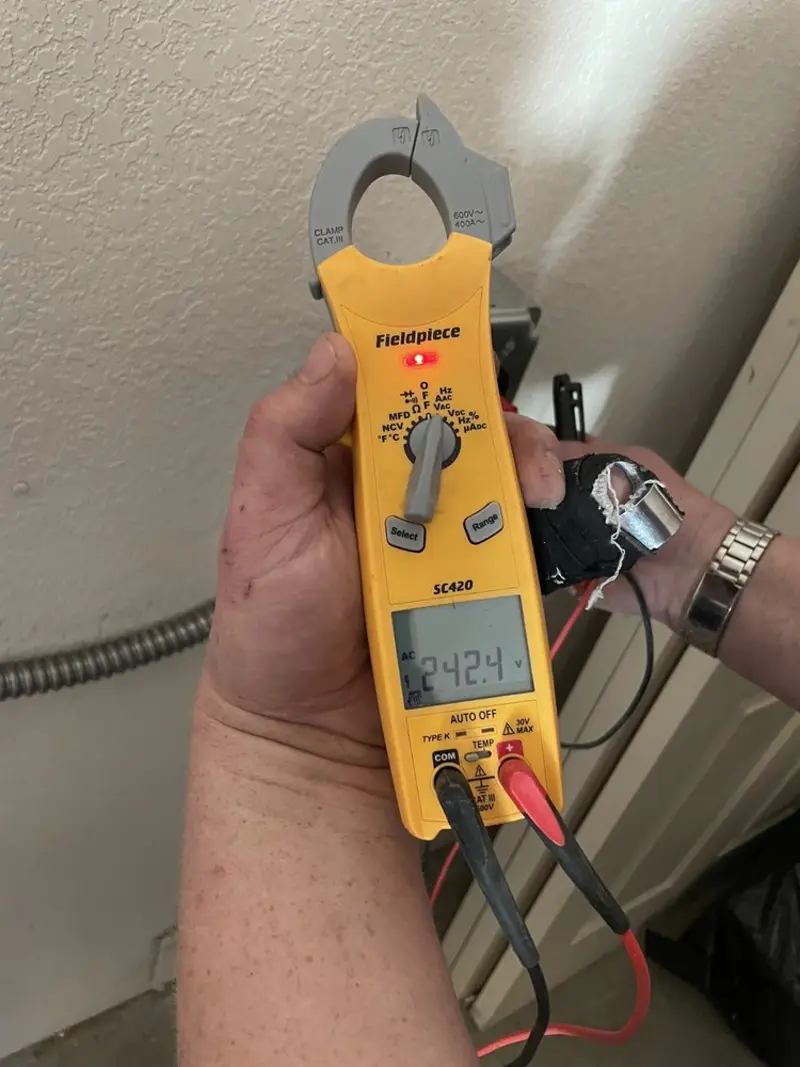 Voltage testing with clamp meter during Recessed Lighting Installation in Irondale